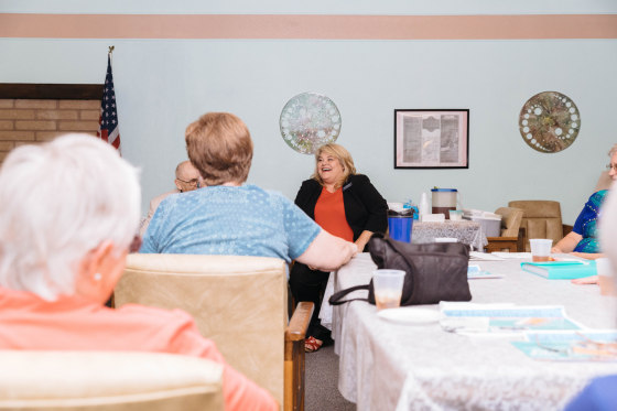 Image: Lesia Romanov speaks with guests during a meet-and-greet