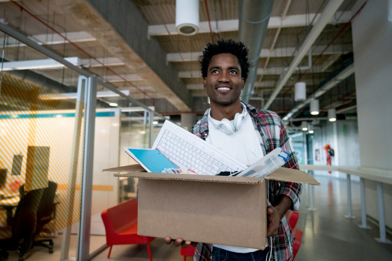 Image: Casual business man moving into a new office