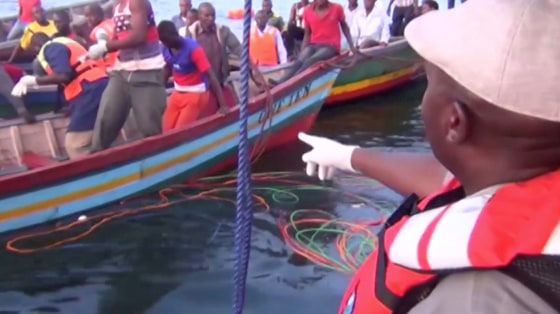 Image: Rescue workers are seen at the scene where a ferry overturned in Lake Victoria