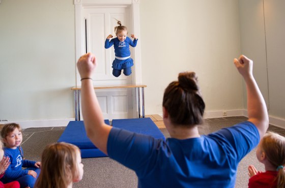 Image: Girls jump off a table during playtime