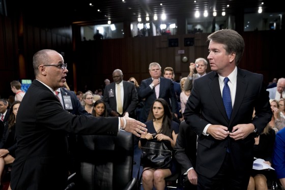 Image: Fred Guttenberg, the father of Jamie Guttenberg who was killed in the Stoneman Douglas High School shooting in Parkland, Florida, left, attempts to shake hands with Brett Kavanaugh