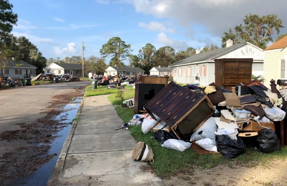 Residents in New Bern, North Carolina, drag their belongings damaged by Hurricane Florence to the side of the road on Sept. 27, 2018.