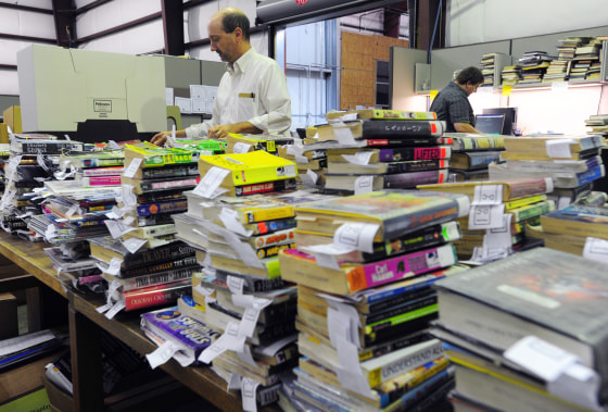 Sorting through books to be discarded at the Lafayette Public Library warehouse in Louisiana in 2013.