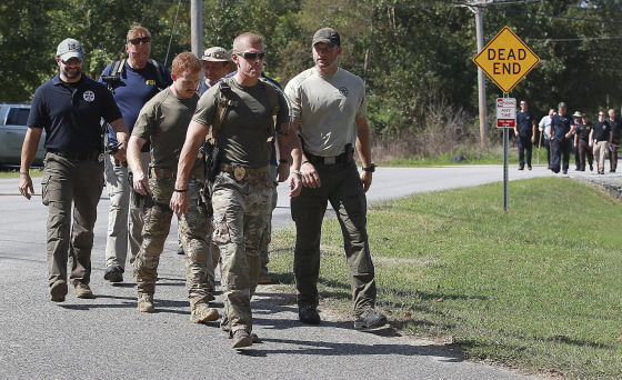 Image: A search team turns onto Rankin Lake Road in Gastonia