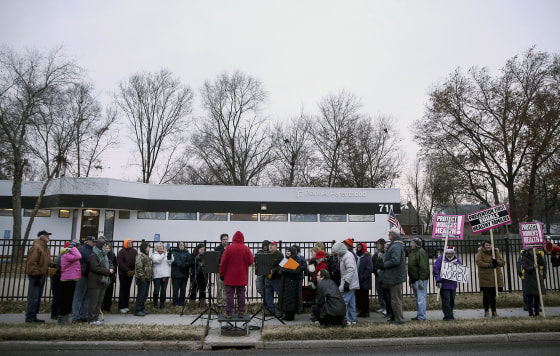 Anti-abortion advocate Joanne Schrader of Fulton (in red) speaks during a news conference organized outside the Planned Parenthood Columbia Health Center on Dec. 12, 2016 in Columbia, Missouri.