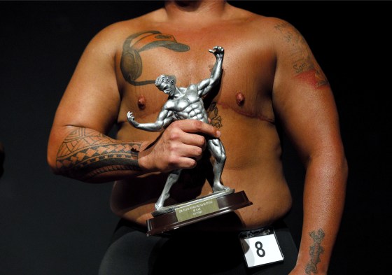 Image: Kennedy Conners, of Conyers, Ga., who transitioned from female a year and half ago, holds his trophy after winning the heavyweight class in the International Association of Trans Bodybuilders competition