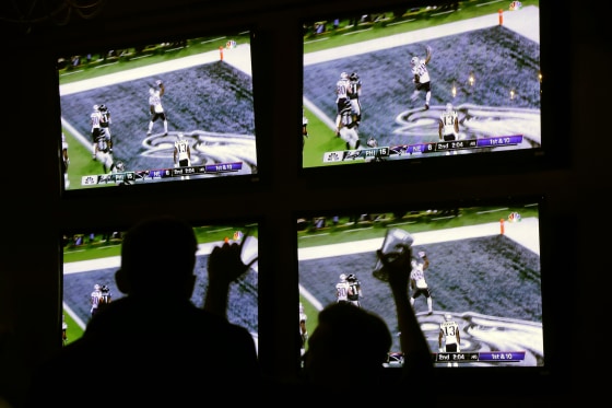 Fans at a Boston bar react to the New England Patriots' first touchdown during the first half of the Super Bowl on Feb. 4, 2018.