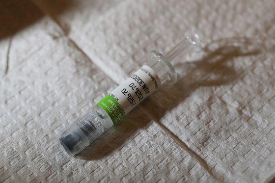 Image: An influenza vaccination is prepared for a patient at the CVS Pharmacy store's MinuteClinic in Miami, Florida