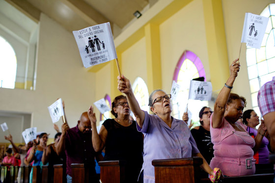 Image: Worshippers wave paper flags during a service at a Methodist Church in Havana