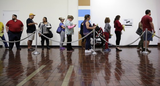 Image: Voters wait in line to cast ballots at an early polling site in San Antonio
