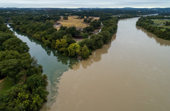 Barton Creek meets the dirty waters of the rain-swollen Lady Bird Lake in Austin, Texas, on Tuesday. Recent floods have caused a citywide boil-water notice that could last 10-14 days.