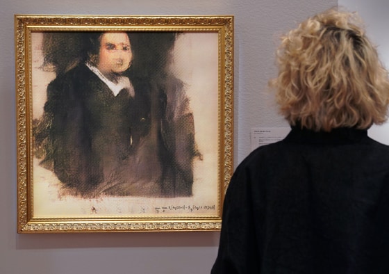 Image: A woman looks at a work of art created by an algorithm by French collective named OBVIOUS which produces art using artificial intelligence