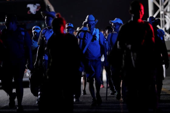 Image: Migrants, travelling with a caravan of thousands from Central America en route to the United States, walk to Santiago Niltepec from San Pedro Tapanatepec