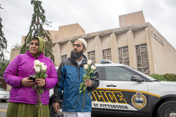 Samina Mohamedali, left, and her husband Kutub Ganiwalla, members of the Dawoodi Bohra Muslim community, both of North Hills, prepare to place flowers on a memorial in front of the Tree of Life Congregation in Squirrel Hill neighborhood of Pittsburgh on Oct. 28, 2018.