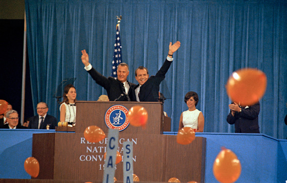 Republican presidential candidate Richard Nixon, waving right, and his running mate Spiro Agnew react to cheers