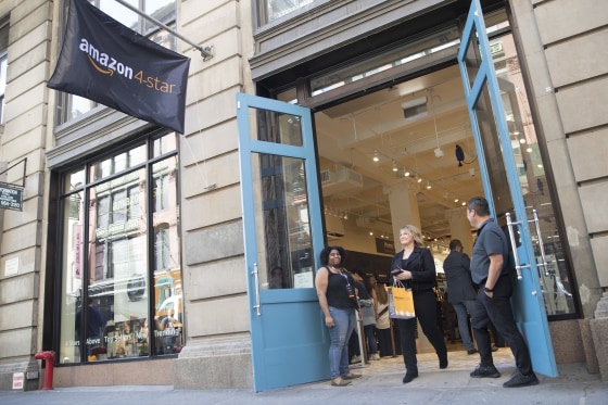 A shopper leaves the Amazon 4-star store in the Soho neighborhood of Manhattan after making a purchase