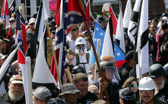 White nationalist demonstrators walk into the entrance of Lee Park in Charlottesville, Virginia, on Aug. 12, 2017.