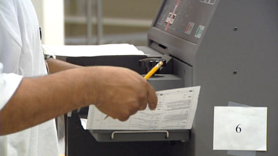 A paper ballot being stamped that has been filled out and sent in by a Oregon resident.