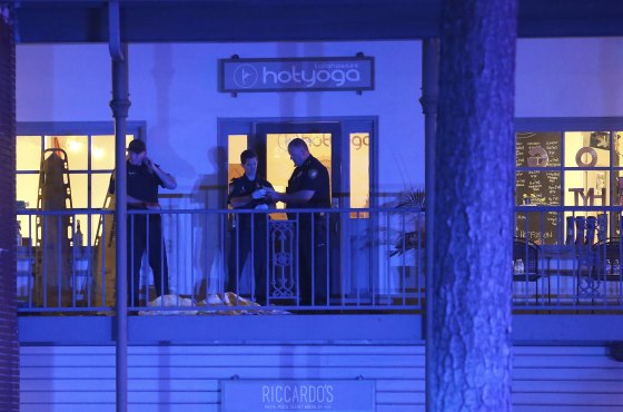 Police investigate the scene of a shooting at a yoga studio in Tallahassee, Florida