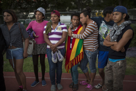 Migrants stand on the race track at the Jesus Martinez stadium, which was turned into a makeshift shelter for the migrant caravan, in Mexico City.