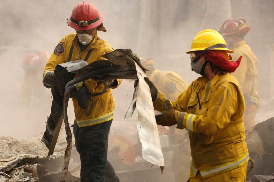 Image: Cal Fire firefighters comb through a house destroyed by the Camp Fire in Paradise