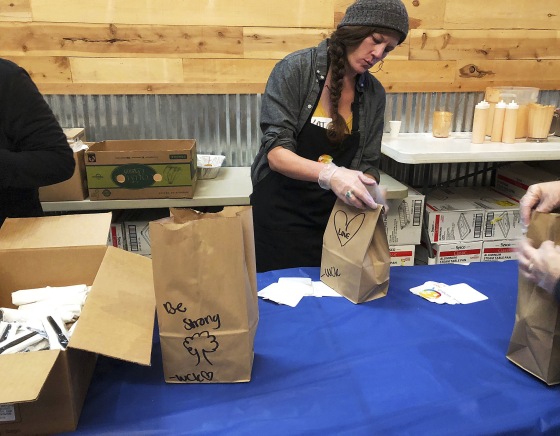 Image: Katherine Clement prepares bagged lunches for firefighters as she works with the nonprofit World Central Kitchen