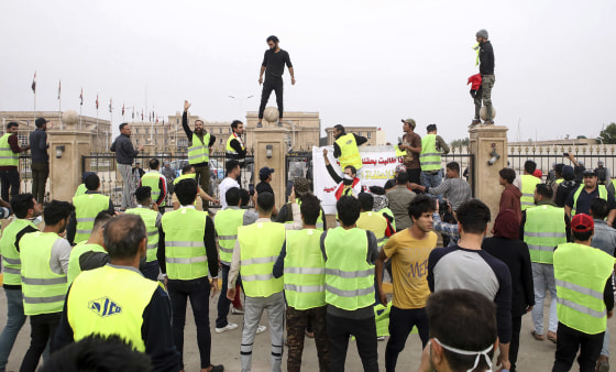Image: Protesters chant slogans in front of the provincial council building during a demonstration demanding better public services and jobs in Basra, southeast of Baghdad, Iraq