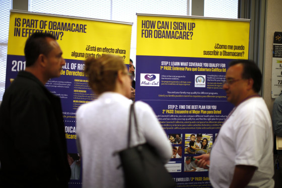 Image: Julian Gomez, right, explains Obamacare at a healthcare enrollment event in Commerce, California, in 2014.