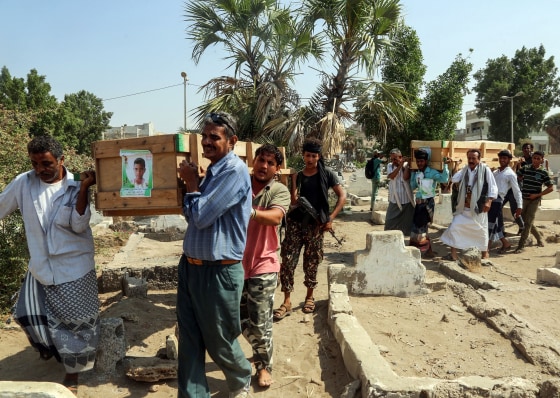 Image: Mourners walk through a cemetery carrying the coffin of one of the victims of reported bombardment in the rebel-held Hodeida, Yemen, on Dec. 10, 2018.