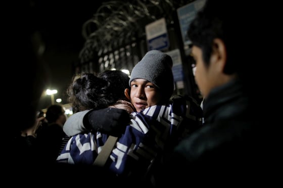 Image: An unaccompanied minor, part of a caravan of thousands from Central America, reacts as he is allowed to enter the United States to apply for asylum at the Otay Mesa port of entry on Dec. 17, 2018.