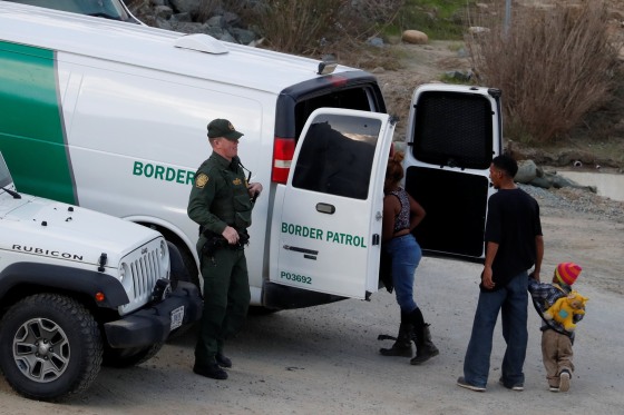 Image: U.S. Customs and Border Protection (CBP) officials detain a group of migrants, part of a caravan of thousands from Central America trying to reach the United States, after they crossed illegally from Mexico to the U.S, as seen from Tijuana