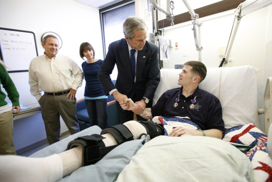 Image: President George W. Bush shakes hands with U.S. Army Staff Sgt. Kyle Stipp after presenting him with two Purple Heart medals at Walter Reed Army Medical Center on Dec. 22, 2008.