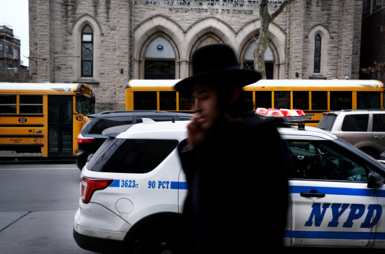 Image: An Orthodox Jewish man walks through Brooklyn the day after five people were stabbed at a Hannukah gathering in Monsey, N.Y., on Dec. 29, 2019. Security has been increased in some Jewish communities following recent attacks.