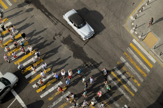 Image: Tourists walk through historic Old Havana in Cuba on March 20, 2016.