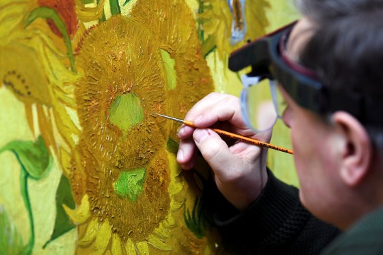Image: Renovator Rene Boitelle works on a restoration of Van Gogh's painting \"Sunflowers\" at Van Gogh Museum in Amsterdam