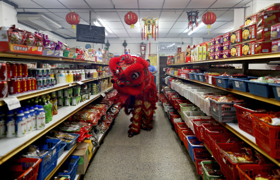 Dancers perform a lion dance inside a local shop during celebrations of the Chinese Lunar New Year of the Monkey in Chinatown in Panama City