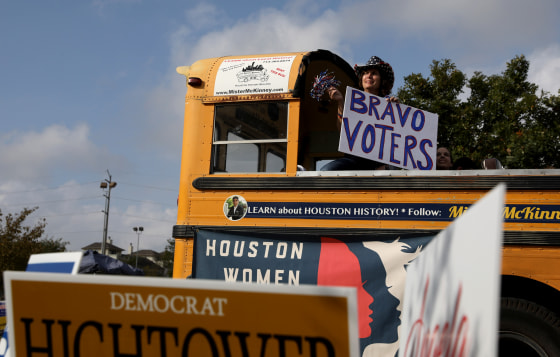 Image: A woman shows support for voters outside the Metropolitan Multi-Service Center polling place in Houston on election day on Nov. 6, 2018.