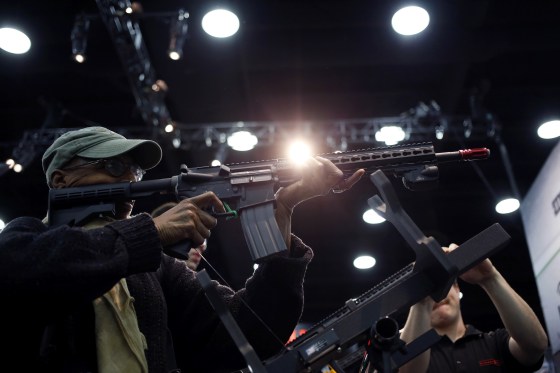 Image: An attendee holds an AR-15 style gun on the exhibit floor at the National Rifle Association's annual meeting in Louisville, Kentucky, on May 20, 2016.