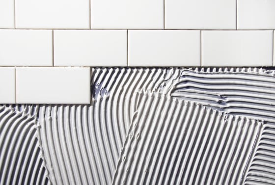 Image: Tile placed over mastic in home renovation.