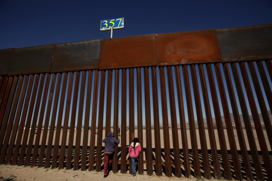 Image: Children peek through the border fence at Anapra neighbourhood in Ciudad Juarez