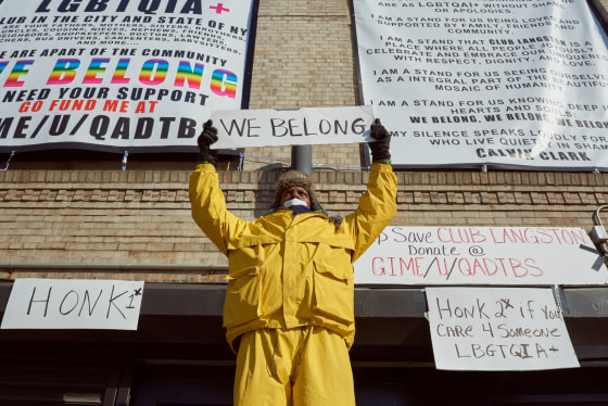 Calvin Clark stands in front of Club Langston in a silent protest in Brooklyn, New York.