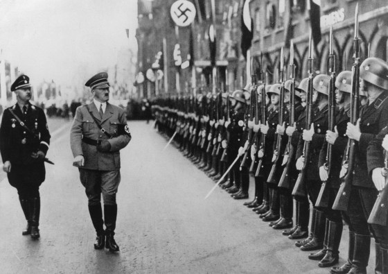 Image: Adolf Hitler and the head of the SS, Heinrich Himmler, walking past a guard of honor in Nuremberg, September 1935