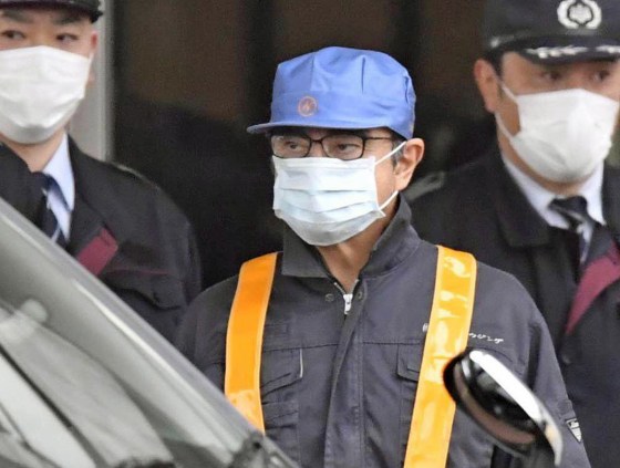 Image: A masked man, believed to be former Nissan Chairman Carlos Ghosn, leaves Tokyo's Detention Center