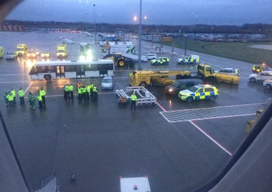 Image: Emergency personnel wait for passengers to disembark a flight from Barbados at Gatwick Airport in England on March 6, 2019.
