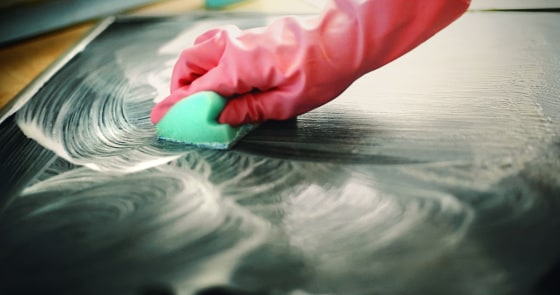 Cleaning kitchen stove.