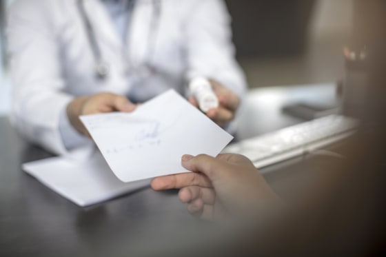 Image: Doctor giving patient a note