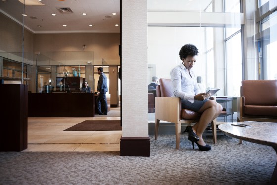 Image: Businesswoman using tablet computer while sitting on sofa in office