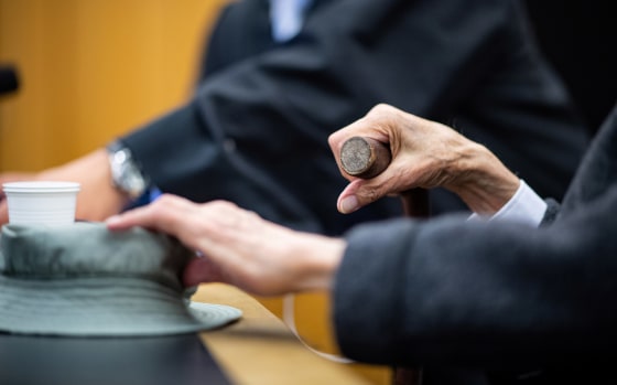 Image: A wheelchair-bound man appeared in court in Muenster, Germany, accused of helping to murder hundreds of people at a Nazi concentration camp during World War Two