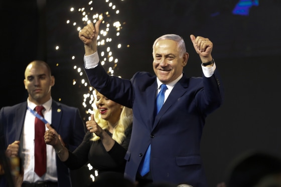 Image: Israel's Prime Minister Benjamin Netanyahu waves to his supporters after polls for Israel's general elections closed in Tel Aviv