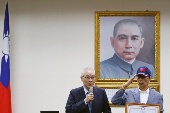Image: Terry Gou, founder and chairman of Foxconn, holds a testimonial next to the chairman of the party, Wu Den-yih, as he announces seeking the nomination of Taiwan's opposition Kuomintang party to run for the island's presidency, in Taipei